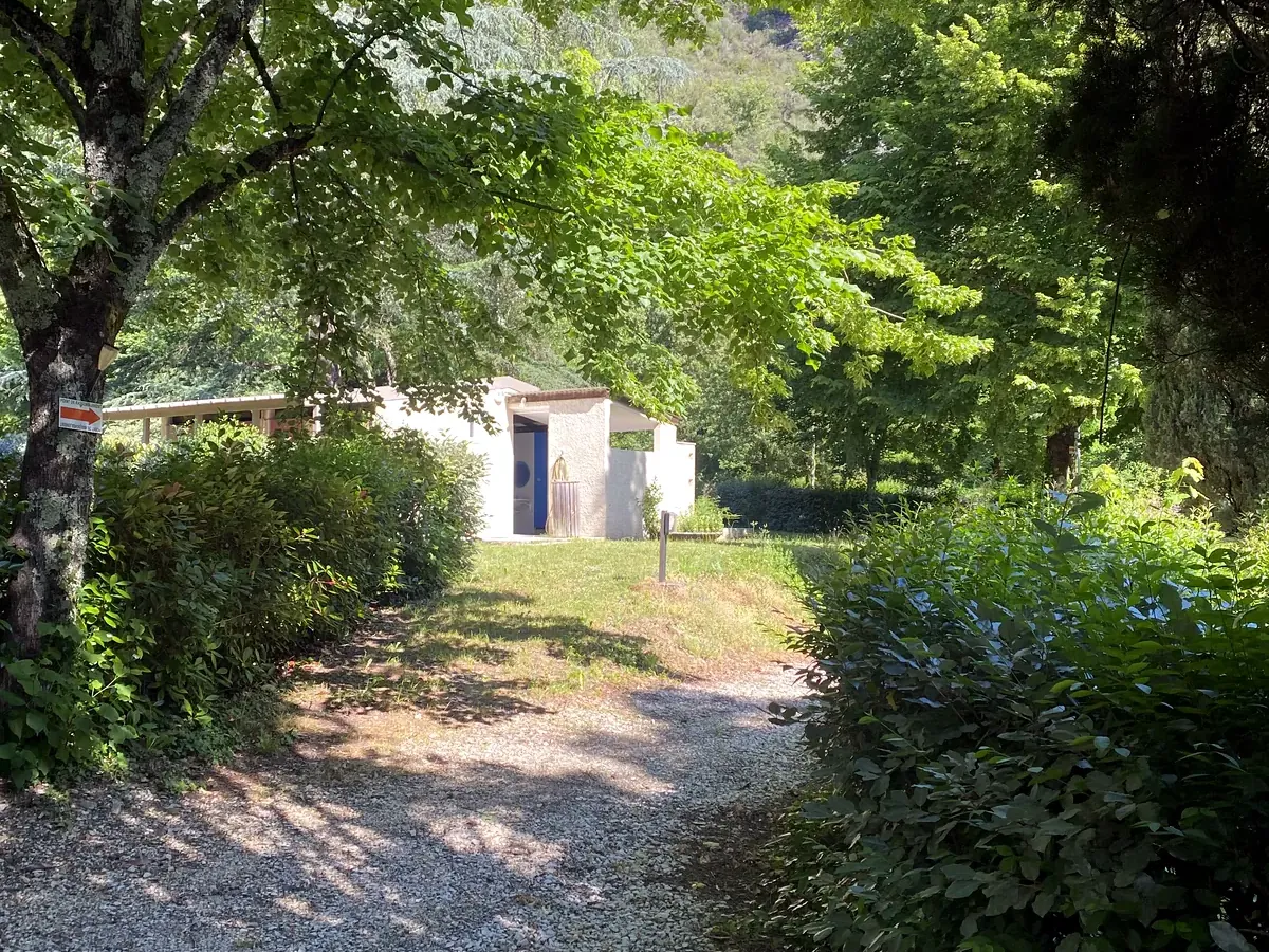 Allée ombragée du camping vers le bloc sanitaire